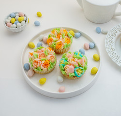 Top view decorated cupcakes with Easter eggs on white Background.