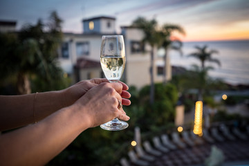 Woman holding wine glass.