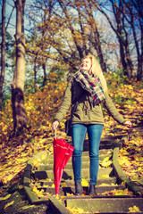 Woman walking in park with umbrella