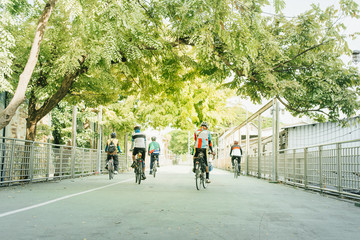 Fototapeta na wymiar people ride bicycle in public park