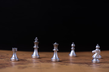 Chess pieces on world map with black background. concept of strategy