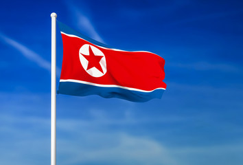 Waving flag of North Korea on the blue sky background