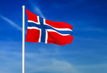 Waving flag of Norway on the blue sky background