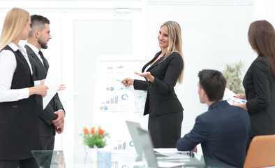 business woman doing a presentation to his business team.