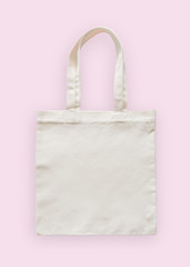 Tote bag canvas fabric cloth eco shopping sack mockup blank template isolated on pastel pink background (clipping path)