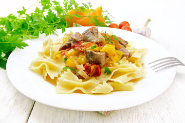 Farfalle with turkey and vegetables in sauce on board