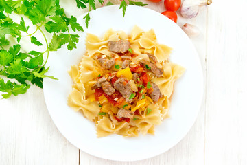 Farfalle with turkey and vegetables on light board top