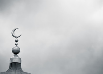 Islamic symbol on mosque in overcast weather