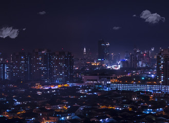 A sea of lights in the city: aerial night view of Petaling Jaya leading to Kuala Lumpur and the Petronas towers