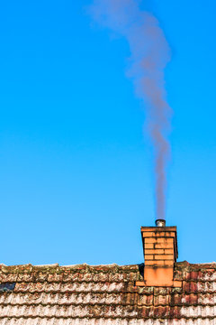 Old Roof Of House With Chimney Smoke In Air, Environment Pollution And Smog In Winter, Ecological Problems