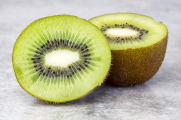 Half of juicy kiwi fruit on background.  