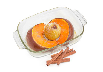Baked pumpkin and apple in glass casserole pan and cinnamon