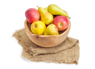Red and yellow apples and pears in wooden fruit bowl
