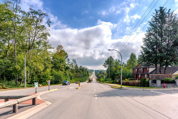 Naklejka premium Cars go on the road on the outskirts of the city, in the suburbs
