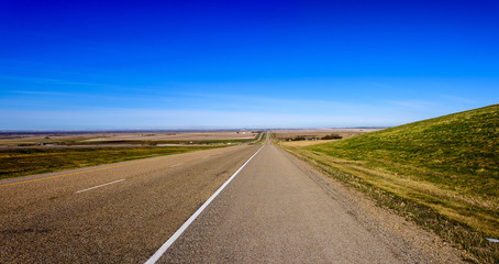 Fototapeta na wymiar Beautiful panorama of an asphalt road, a highway with wide fields
