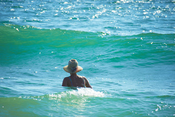 Woman with hat in the sea