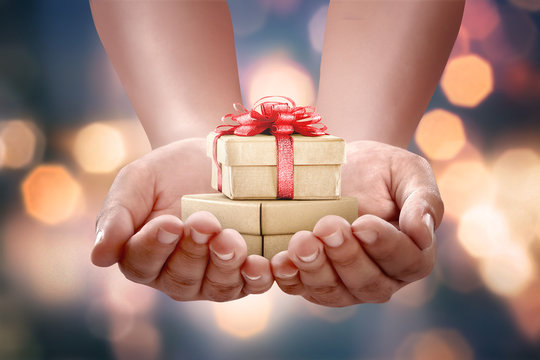 Human hands holding gift box for boxing day