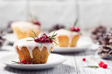 Gartenposter Christmas mini cake with sugar icing, cranberries and rosemary © ritaklimenko
