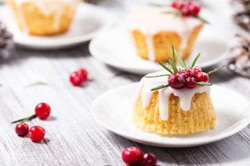 Christmas mini cake with sugar icing, cranberries and rosemary