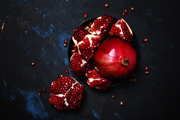 Red Pomegranate On The Plate, Black Background, Top View