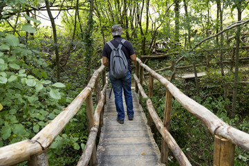 hiker walk on wooden bridge