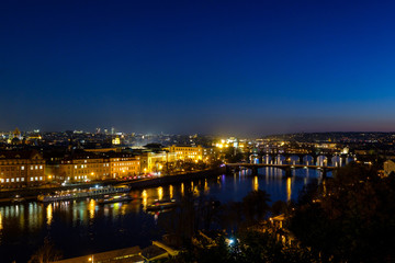 Fototapeta premium Panorama of the old part of Prague from the Letna park at dusk. Beautiful view on the bridges over the river Vltava at sunset. Old Town architecture, Czech Republic.