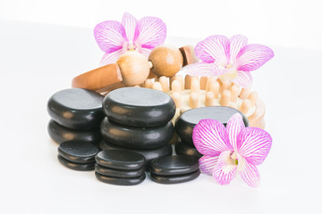 Fototapeta na wymiar Spa therapy with hot stones, massage roller and cellulite massager 
