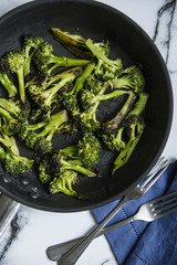 Grilled broccoli roses in a frying pan. Top view shot, healthy lifestyle concept.