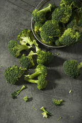 Broccoli pieces on a granite tabletop. Cooking preparation. Healthcare concept.