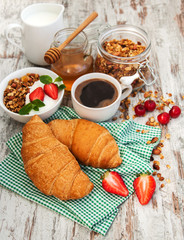 Croissant, coffee, granola  and strawberry
