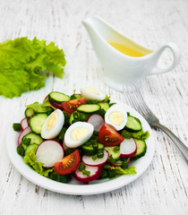 Spring salad with eggs, cucumbers and radish