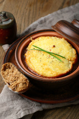 Onion soup with potato pancake in bowl