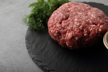 Raw minced meat on slate background