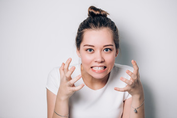 Close up isolated portrait of young annoyed angry woman holding hands in furious gesture. Young...