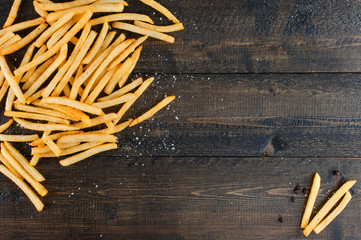 Wooden background with potato fries