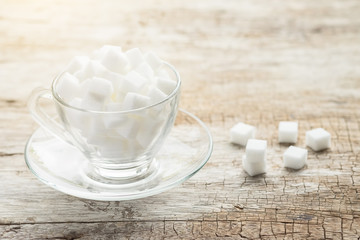 sugar in cup on wood table.Vintage tone retro filter effect,soft focus(selective focus)