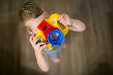 Cute boy becoming photographer