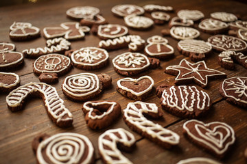 Traditional homemade Christmas ginger and chocolate cookies decorated with white sugar painting