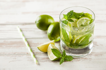 Mojito cocktail on white wood background