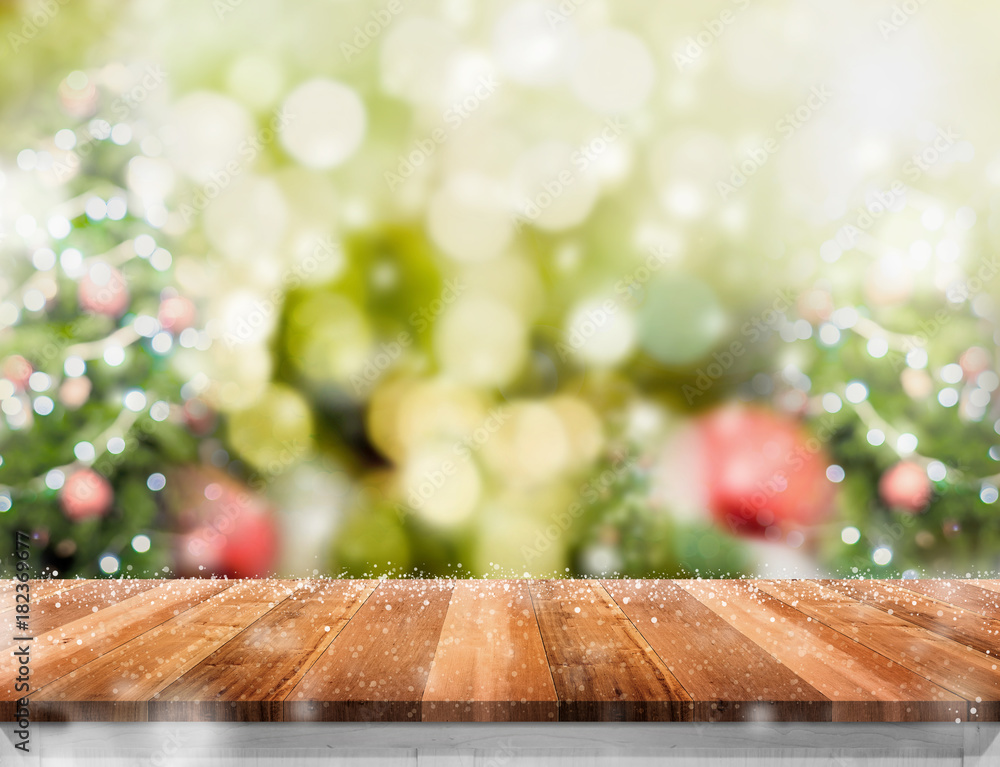 Aufkleber Empty wooden table with abstract blur christmas tree and snow falling background with bokeh,Holiday backdrop,Mock up banner for display of product for promotion online