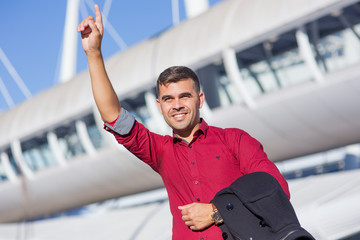Portrait of positive businessman hailing cab