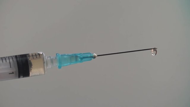 Medical syringe with drugs on blurry background