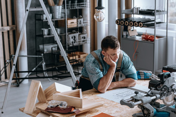 Thoughtful engineer sitting at desk