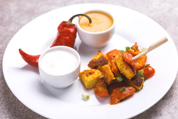 Indian cuisine. Paneer Tikka Kabab. Asian salad. Horizontal view