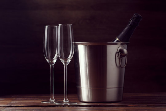Picture of two empty wine glasses, bottle of champagne