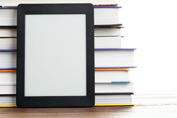 Image of blank black picture frame near stack of books