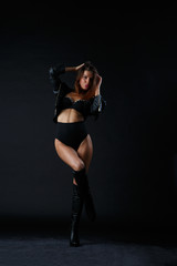 Fototapeta premium Image of woman with hands behind head in boots
