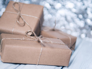 gift box wrapped with Kraft paper on bokeh background