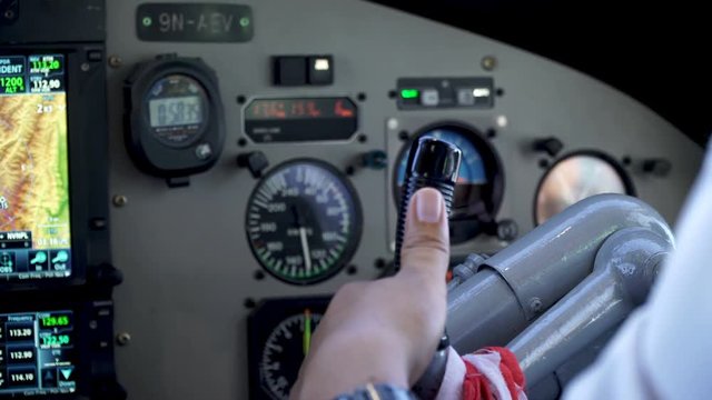 Cockpit inside. The pilot's hand on the helm of the aircraft. The plane is preparing to take off