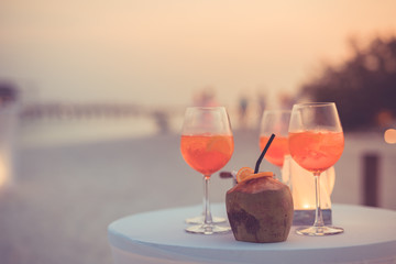 Exotic summer drinks, blur sandy beach with people having fun talking, chilling on background